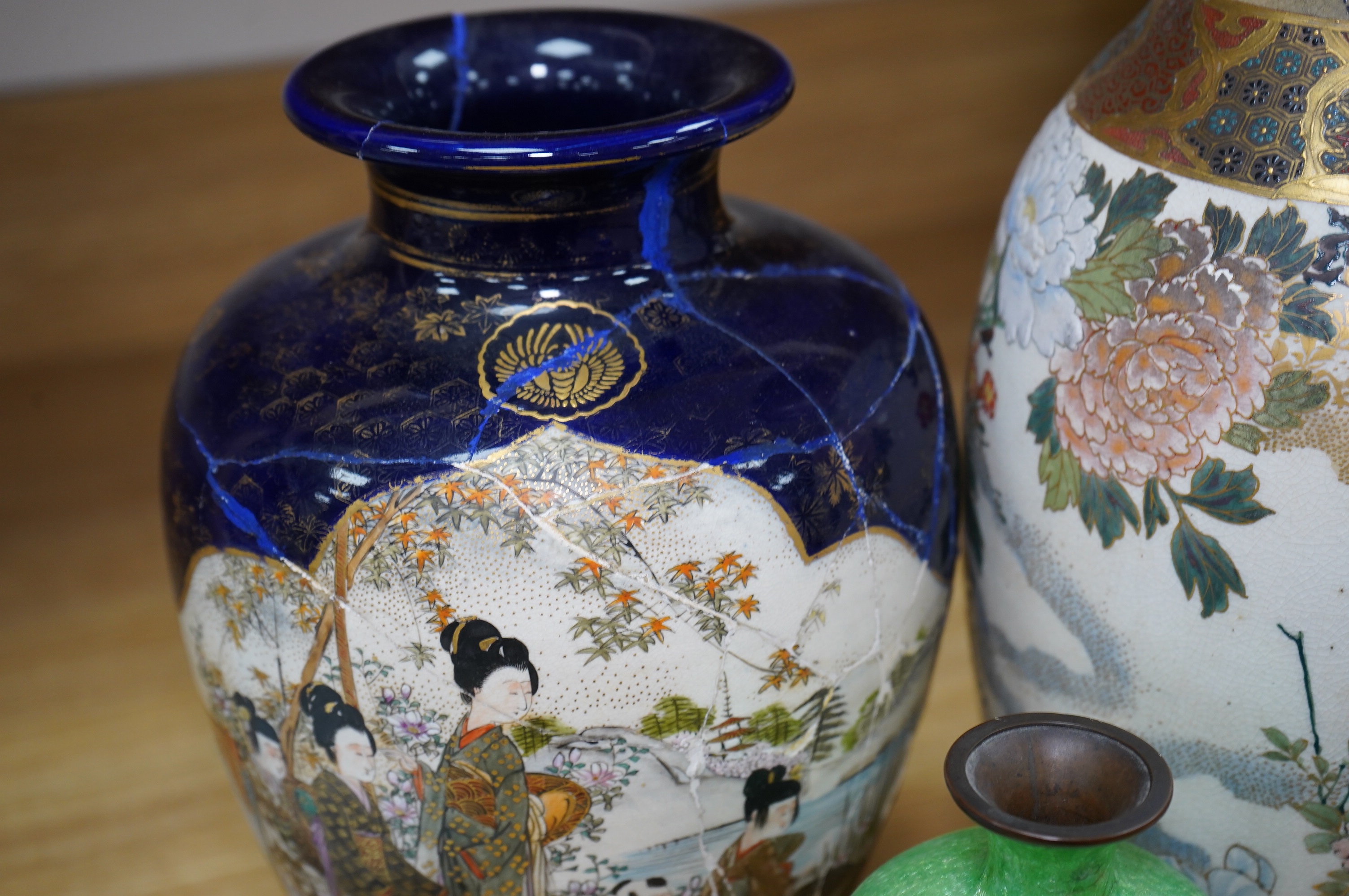 A pair of Japanese Satsuma vases on stands, a pair of floral enamel vases and another Satsuma pottery vase, largest 35cm high. Condition - poor